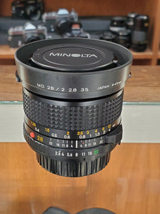 Mint Minolta MD 28mm f2.8 wide angle lens with Hood, CLAd, Canada - Paramount Camera & Repair
